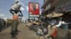 A poster shows John Dramani Mahama, Ghana's interim president and National Democratic Congress (NDC) presidential candidate, on a street in Accra.