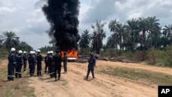 FILE - Firefighters and security officers respond at the site of an illegal refinery explosion in Rivers, Nigeria, on March 3, 2023. A similar explosion on Oct. 1, 2023, in Rivers killed at least 15 people.