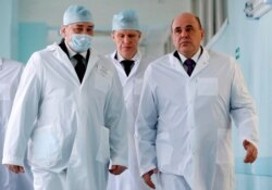 Russian Prime Minister Mikhail Mishustin, right, visits the Kurgan Emergency Hospital in Kurgan, Russia, Feb. 25, 2020.