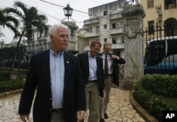 FILE - US Congressmen William Delahunt, D-Mass, Jeff Flake, R-Ariz., and Jerry Moran, R-Kan. (L-R) arrive to Cuba's Foreign Ministry in Havana, Dec. 16, 2006.