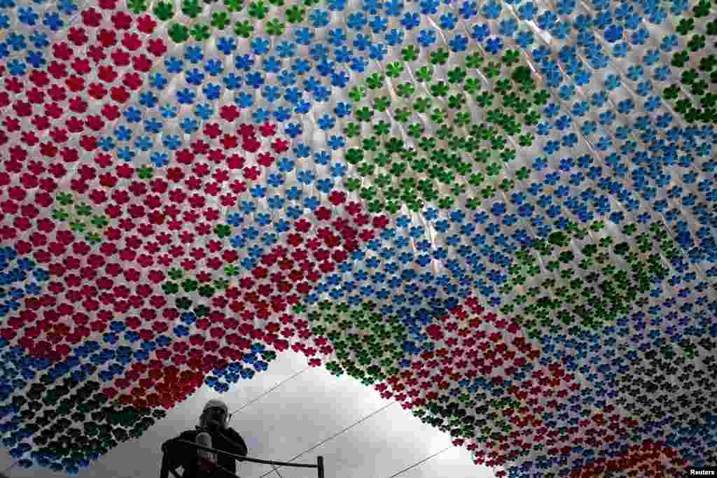 A worker stands next to an installation made of plastic bottles in Tegucigalpa, Honduras, March 31, 2015. The Museum of National Identity is working on installations made from recycled plastic bottles as a way to encourage recycling in the community, local media reported.