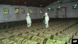 RUSSIA -- Two Russian soldiers make a routine check of metal containers with toxic agents at a chemical weapons storage site in the town of Gorny, May 20, 2000.