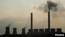 FILE - Smoke rises from the Duvha coal-based power station owned by state power utility Eskom, in Mpumalanga province, South Africa. Taken Feb. 18, 2020. 