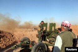 Kurdish Peshmerga forces fire a weapon during clashes with Islamic State militants in a village east of Mosul, Iraq, May 29, 2016.