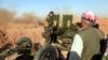 Kurdish Peshmerga forces fire a weapon during clashes with Islamic State militants in a village east of Mosul, Iraq, May 29, 2016. 