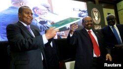 Central African Republic President Faustin-Archange Touadera is seen with Sudan's President Omar al-Bashir after signing a peace deal between the Central African Republic government and 14 armed groups following talks in the Sudanese capital Khartoum, Sudan, Feb. 5, 2019.