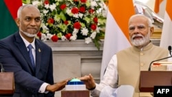 India's Prime Minister Narendra Modi (R) and Maldives President Mohamed Muizzu virtually inaugurate the new runway at Maldives' Hanimadhoo International Airport, during a joint media briefing at the Hyderabad House in New Delhi on October 7, 2024.