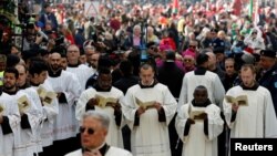 Clergymen attend Christmas celebrations at Manger Square outside the Church of the Nativity in Bethlehem, in the Israeli-occupied West Bank, Dec. 24, 2018.