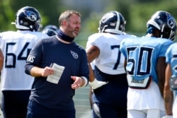 FILE - Tennessee Titans outside linebackers coach Shane Bowen instructs his players during NFL football training camp in Nashville, Tenn., Aug. 24, 2020.