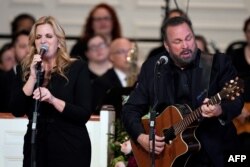 FILE - Garth Brooks and Trisha Yearwood perform "Imagine" at a tribute service for former US first lady Rosalynn Carter at Glenn Memorial Church at Emory University on November 28, 2023 in Atlanta.