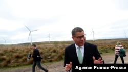 FILE - COP26 President Alok Sharma attends an event at Whitelee Windfarm, outside Glasgow, Scotland, May 14, 2021.