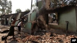 Muslims pour water to a damaged mosque following fresh anti-Muslim violence broke out in Okkan, 64 kilometers (40 miles) north of Rangoon, Burma, May 1, 2013.