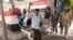A man dances as women sing national songs in front of a polling station during the second day of the presidential in Cairo, Egypt, Tuesday, March 27, 2018. Egyptians were voting Tuesday on the second day of a lackluster election that President Abdel-Fattah el-Sissi is virtually certain to win after all serious rivals were either arrested or intimidated into dropping out of the race ahead of balloting.