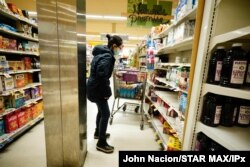 New Yorkers wear protective masks and strip store shelves of supplies as the coronavirus continues to wreak havoc throughout the city, Mar 13, 2020.