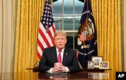FILE - President Donald Trump speaks from the Oval Office of the White House as he gives a prime-time address about border security, Jan. 8, 2018.