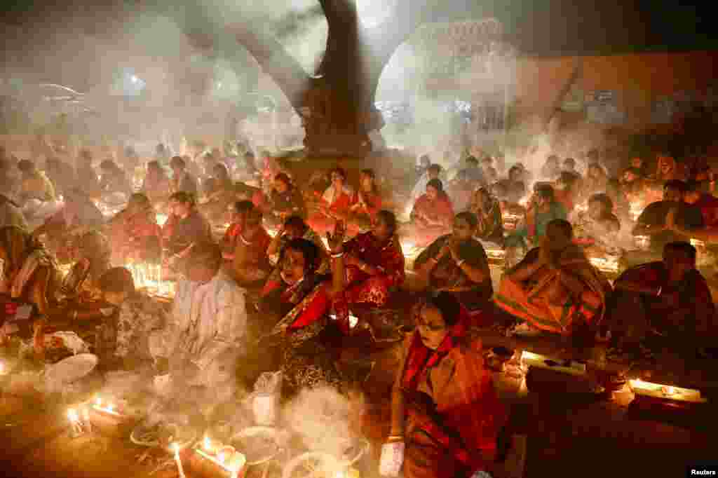 Hindu devotees pray to Lokenath Brahmachari, a Hindu saint, as they observe Rakher Upabash, in Narayanganj, Bangladesh, Nov. 6, 2021.