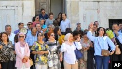 FILE - Lawyers and activists gather on the steps of the Palace of Justice during a protest in Tunis, Tunisia, Wednesday, June 8, 2022. 