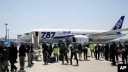 Japanese journalists gather to cover a test flight of an All Nippon Airways Boeing 787 at Haneda International Airport in Tokyo, April 28, 2013. 