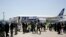 Japanese journalists gather to cover a test flight of an All Nippon Airways Boeing 787 at Haneda International Airport in Tokyo, April 28, 2013. 