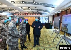 Chinese President Xi Jinping learns about the hospital's operations, treatment of patients, protection for medical workers and scientific research in Wuhan, the epicenter of the novel coronavirus outbreak, Hubei province, March 10, 2020.