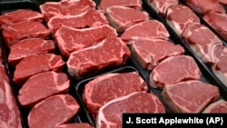 FILE - New U.S. food guidelines suggest eating less red meat and more beans, vegetables and healthy fats. In this Jan. 18, 2010 file photo, beef products are for sale at a food store in McLean, Virginia. (AP Photo/J. Scott Applewhite)