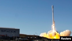 A Falcon 9 rocket carrying a small science satellite for Canada is seen as it is launched, Sept. 29, 2013. 