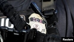 FILE - A U.S. Immigration and Customs Enforcement badge.
