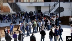 FILE - In this Feb. 20, 2016 file photo people line up to participate in the Democratic caucus at the University of Nevada in Reno, Nev. Nevada Democrats are proposing major changes to their presidential caucuses that could dramatically alter the…