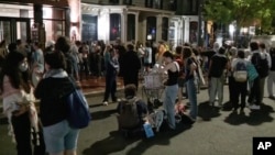 In this photo taken from video, demonstrators protest the Israel-Hamas war at the George Washington University campus in Washington on May 8, 2024. Police say they arrested 33 people while clearing out an encampment on campus.