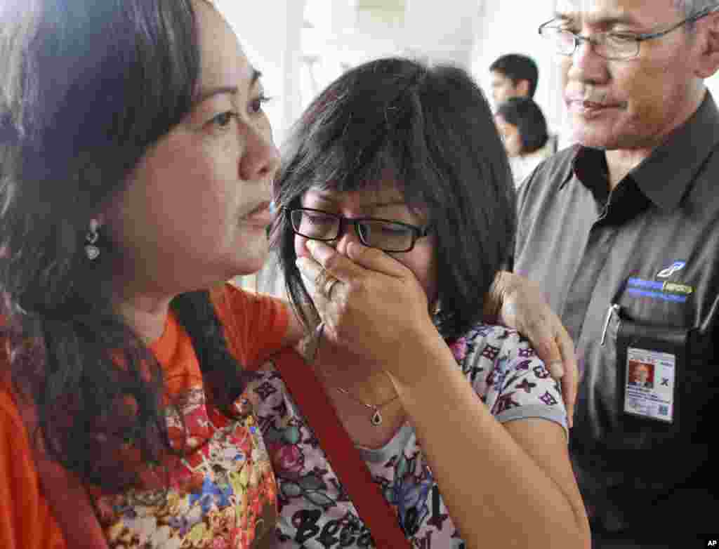 A relative of AirAsia flight 8501 passengers weeps as she waits for the latest news on the missing jetliner at Juanda International Airport in Surabaya, East Java, Indonesia, Dec. 28, 2014.