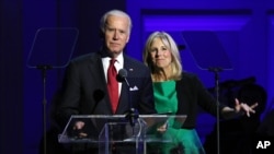 Vice President Joe Biden, left, and Jill Biden speak at 'It Always Seems Impossible Until It Is Done: A Night of Music with ONE and (RED)', in celebration of World AIDS Day, at Carnegie Hall, Dec. 1, 2015, in New York.