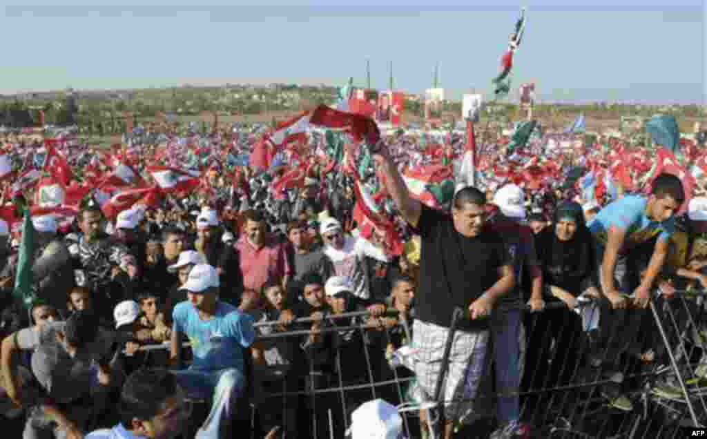 Supporters of Turkish Prime Minister Recep Tayyip Erdogan carry Lebanese and Turkish flags during a rally in the Turkmen village of Kwashra, in the northern Akkar region, in Lebanon, Wednesday, Nov. 24, 2010. Lebanese Prime Minister Saad Hariri and his co