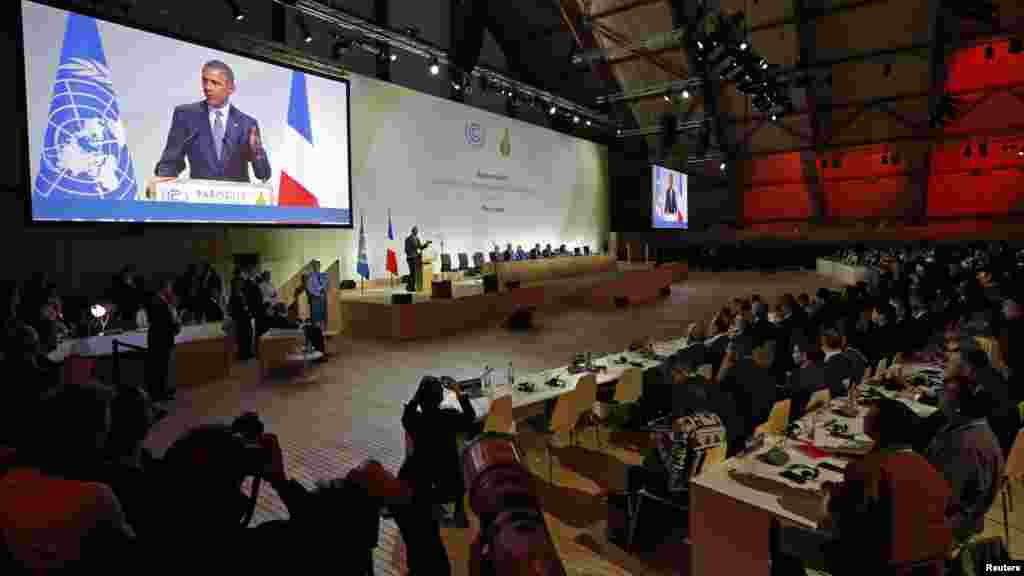 Le président américain Barack Obama visible sur un écran géant lors d’un discours qu’il prononce à la COP21 au Bourget, près de Paris, France, 30 novembre, 2015. 