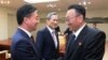 In this photo provided by the South Korean Unification Ministry, Unification Minister Hong Yong-pyo, left, shakes hands with Kim Yang Gon, a senior North Korean official responsible for South Korean affairs, after their meeting at Panmunjom, Aug. 25, 2015.