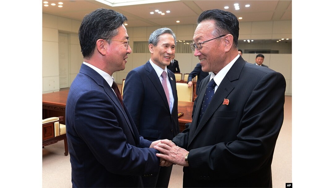 FILE - South Korean Unification Minister Hong Yong-pyo, left, shakes hands with Kim Yang Gon, a senior North Korean official responsible for South Korean affairs, after their meeting at Panmunjom. Yang Gon recently died in a car crash.