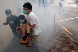 Anti-government protesters run away from tear gas during a march against Beijing’s plans to impose national security legislation in Hong Kong, China, May 24, 2020.