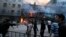 Angry Shi'ite Muslims gather after setting on fire a market outside an Islamic seminary during clashes with Sunni Muslims in Rawalpindi, Pakistan, Nov. 15, 2013. 