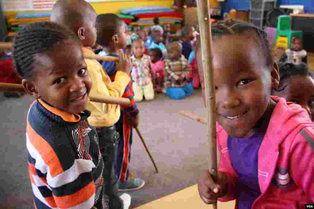 Children at Soweto&#39;s Mapetla Care Center are showered with love by their teachers. Many were left behind when their parents died in South Africa epidemics. (Photo by Darren Taylor)