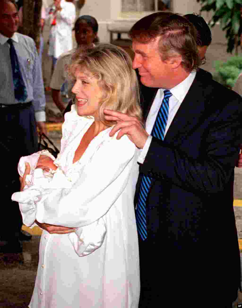 Happy parents Marla Maples, left, and Donald Trump greet the press with their newborn daughter, Tiffany, as they leave St. Mary's Hospital in West Palm Beach, Fla., on Thurs., Oct. 14, 1993. (AP Photo/Hans Deryk)