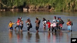 Central American migrants cross the Suchiate River from Mexico to Guatemala, near Tecun Uman, Guatemala, Jan. 21, 2020. 