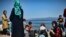 FILE - Migrants from Afghanistan arrive after crossing the Aegean Sea from Turkey with a dinghy on the Greek Mediterranean island of Lesbos on Aug. 6, 2018.