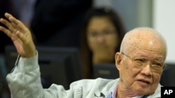 In this photo released by the Extraordinary Chambers in the Courts of Cambodia, Khieu Samphan, former Khmer Rouge head of state, gestures as he sits in the court room U.N.-backed war crimes tribunal in Phnom Penh, Cambodia, Thursday, Aug. 7, 2014.