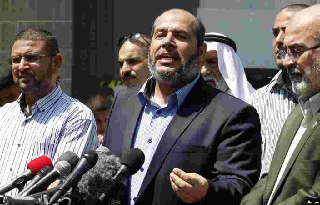 Senior Hamas leader Khalil al-Hayya speaks to the media upon his return to Gaza City from truce talks in Cairo, Aug. 14, 2014