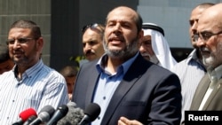 FILE - Senior Hamas leader Khalil al-Hayya speaks to the media upon his return to Gaza City from truce talks in Cairo, Aug. 14, 2014.