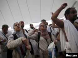 Muslim pilgrims cast stones at pillars symbolizing Satan, during the annual Haj pilgrimage on Eid al-Adha in Mina, near the holy city of Mecca, Sept. 24, 2015.