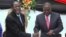FILE - Zimbabwean President Robert Mugabe, left, shakes hands with Prime Minister Morgan Tsvangirai, May 22, 2013, after he signed the new constitution into law in Harare.