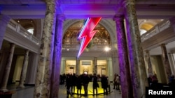 A neon flash representing David Bowie's "Aladdin Sane" stage character is seen at the entrance to the Victoria and Albert Museum to mark the "David Bowie is" exhibition in London, March 20, 2013. 