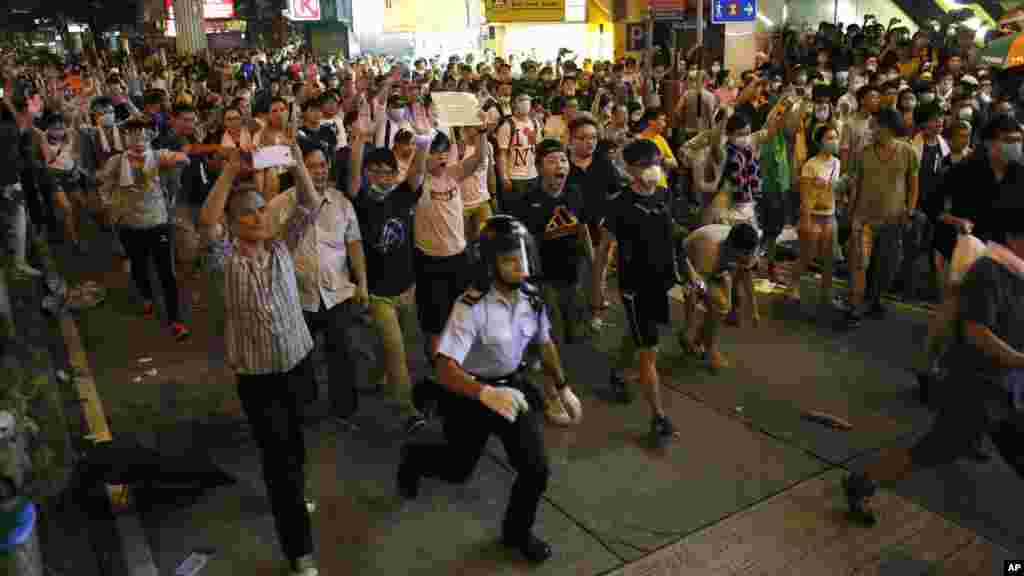 Student protesters mixed with expatriates cause police to retreat in an entertainment area in Hong Kong, late Sept. 28, 2014. 