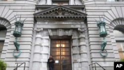 FILE - A man stands outside the main door of the 9th U.S. Circuit Court of Appeals building in San Francisco, Feb. 9, 2017. In President Donald Trump's judicial appointments, he has prioritized nominating federal appeals judges.