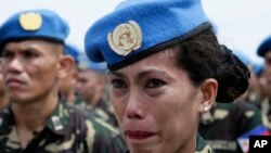 FILE - Philippine Navy Petty Officer 2 Ellen Paculba, one of 157 Philippine troops who were deployed in Haiti as U.N. Peacekeepers, cries during sendoff ceremony, Sept. 22, 2014.